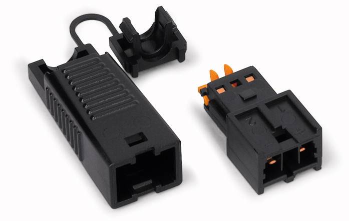 Black electrical connectors with orange contacts, comprising two components, potentially used for electrical connections.