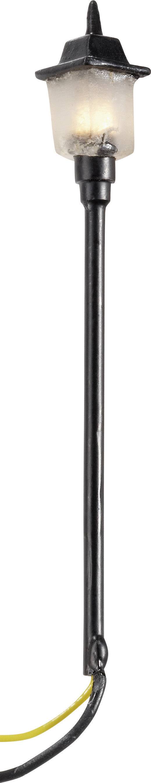 Black lantern with frosted glass, mounted on a tall, slender post, emits soft light. Cable at the bottom end.