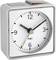 A square alarm clock with a white dial shows 10:10. Black hour and minute hands, along with a thin orange second hand.