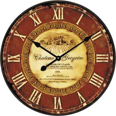 An antique wall clock with Roman numerals and a decorative wine label in the centre, lends a rustic charm.