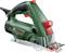 Electric circular hand saw in green and red, side view. It has an ergonomic handle and a visible blade.