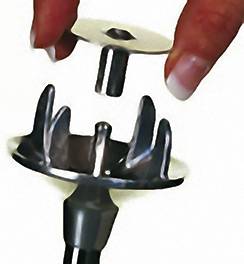 A hand holds the upper part of a food processor over the main attachment; a mixing attachment with multiple blades.