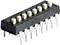 A black DIP switch with eight switches and numbered positions from 0 to 7, used for configuring electronic devices.
