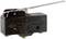 Black micro switch with metal lever arm, suitable for 15A 125-250 VAC or 2A 600 VAC, with multiple international approval marks.