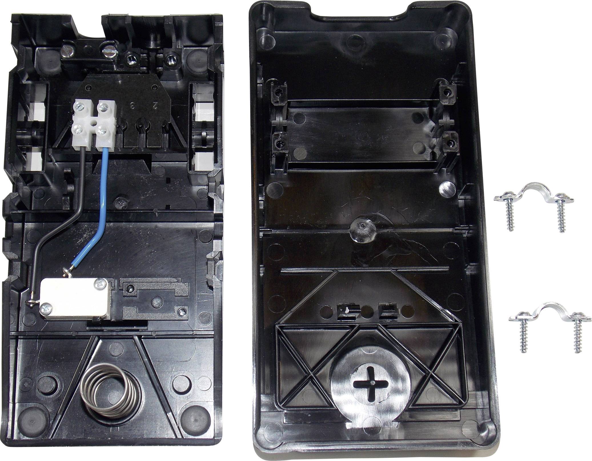 Housing of an electrical device, opened. Left half shows switching mechanism and cables, right half is the cover. Screws and clips are placed beside it.