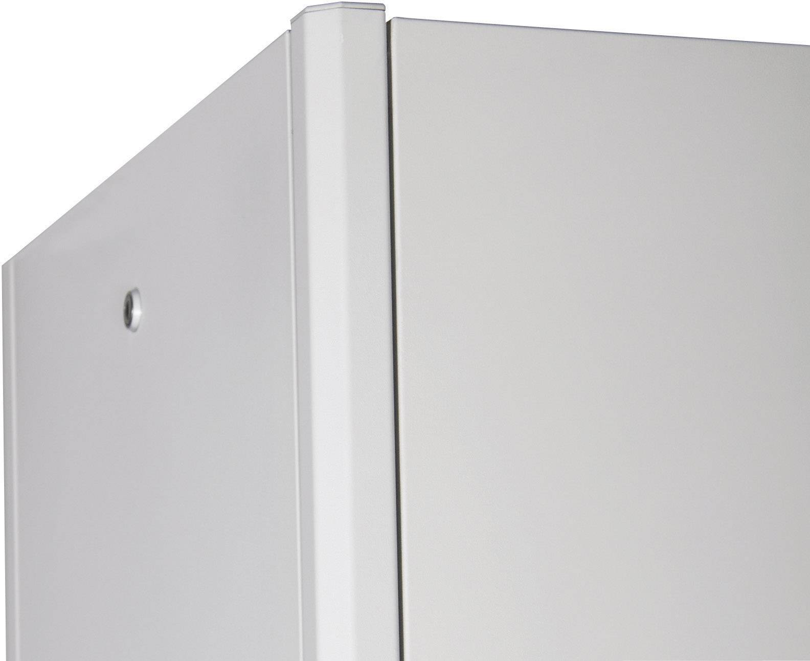 Close-up of a grey metal corner of a rectangular enclosure with a visible fixing element on the left.