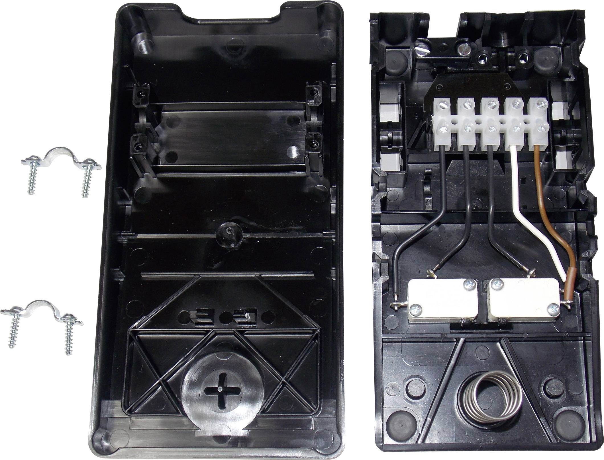 A black plastic casing with a removable cover. Visible wiring and electrical connections on the inside to the right. Screws are lying nearby.