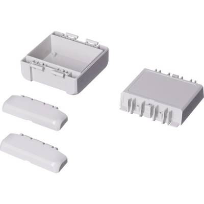 Four rectangular grey plastic components, a housing cover and three modular parts that fit together.