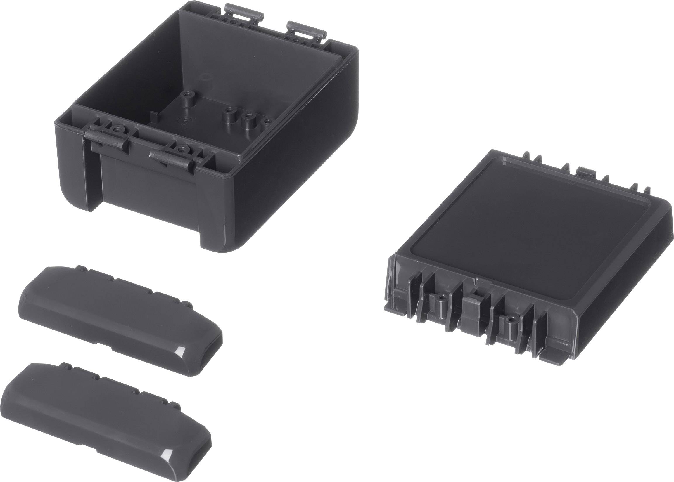 Black plastic enclosure consisting of multiple parts lying separately side by side; suitable for electrical engineering applications.
