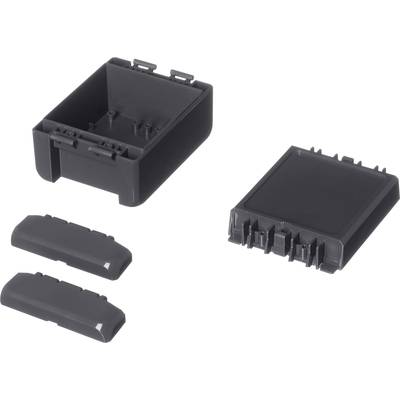 Black plastic enclosure consisting of multiple parts lying separately side by side; suitable for electrical engineering applications.