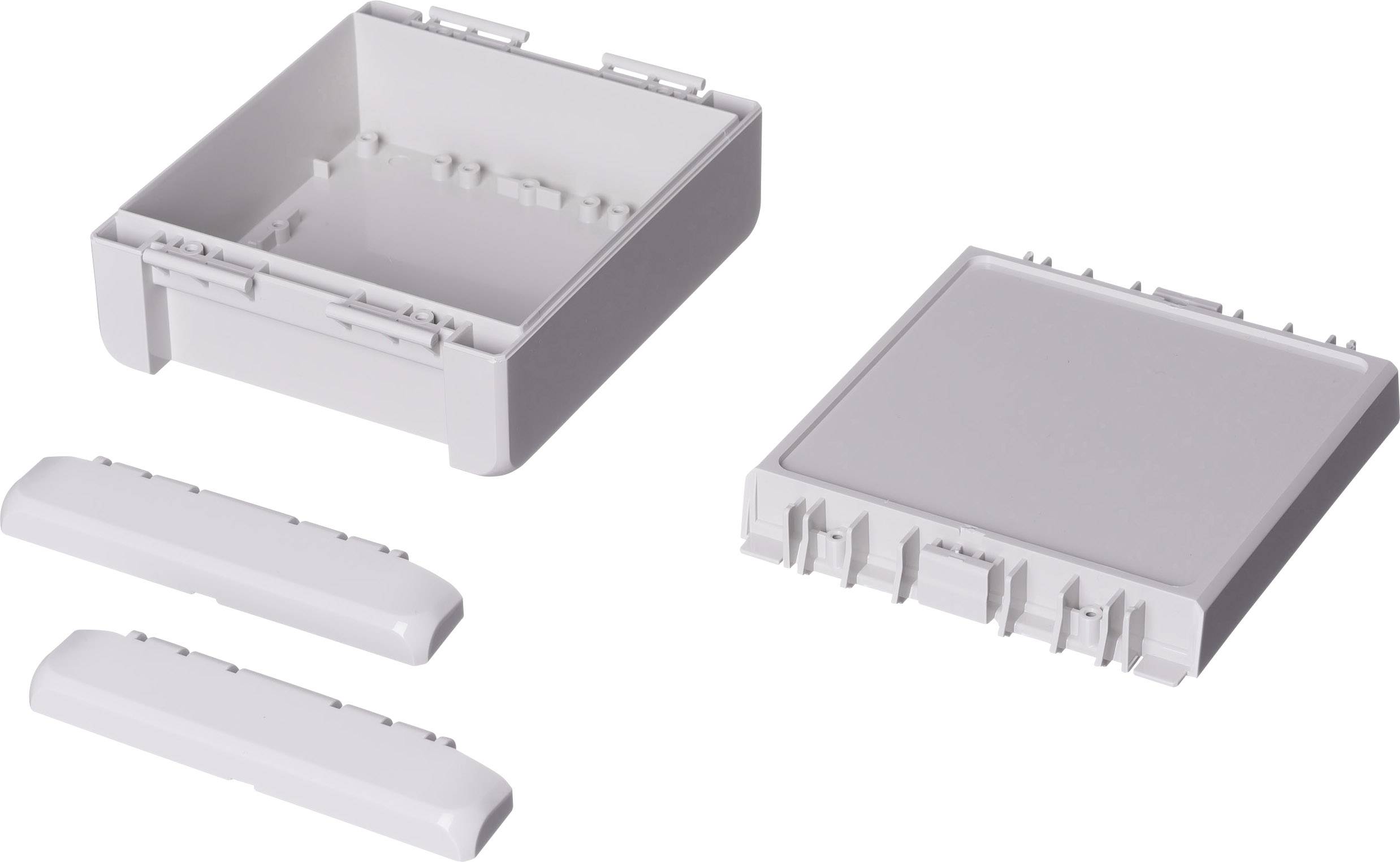 A white plastic housing, consisting of an open base part and a removable lid, alongside two side panels.