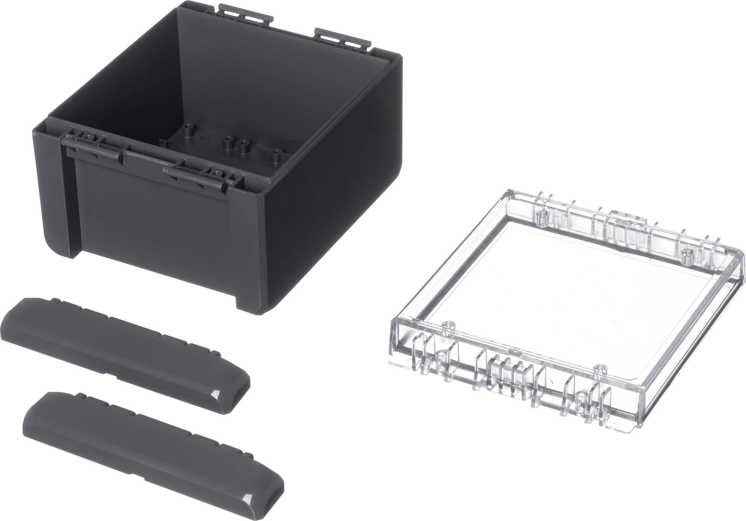 Black plastic box with a removable transparent lid, with two black covers beside it; components of a modular system.