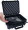 Black, open protective case with foam lining. A hand points to the foam interior, suitable for secure transportation.