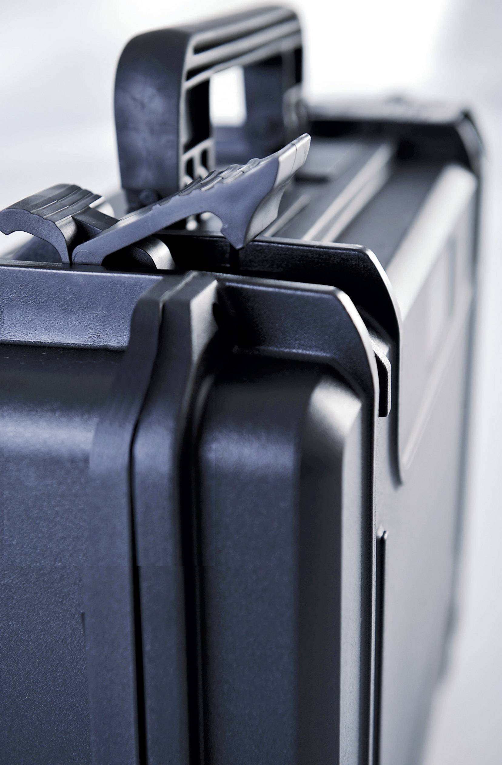 Close-up of a black, robust protective case with a sturdy handle and secure locks, suitable for safely transporting delicate equipment.