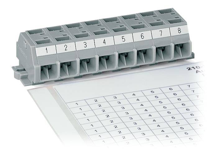 A grey electrical distribution block with eight numbered slots sits on a table with a numerical matrix in the background.