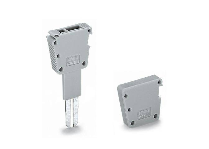 Grey plastic connector key and cover lying side by side. Primarily used in electrical applications.