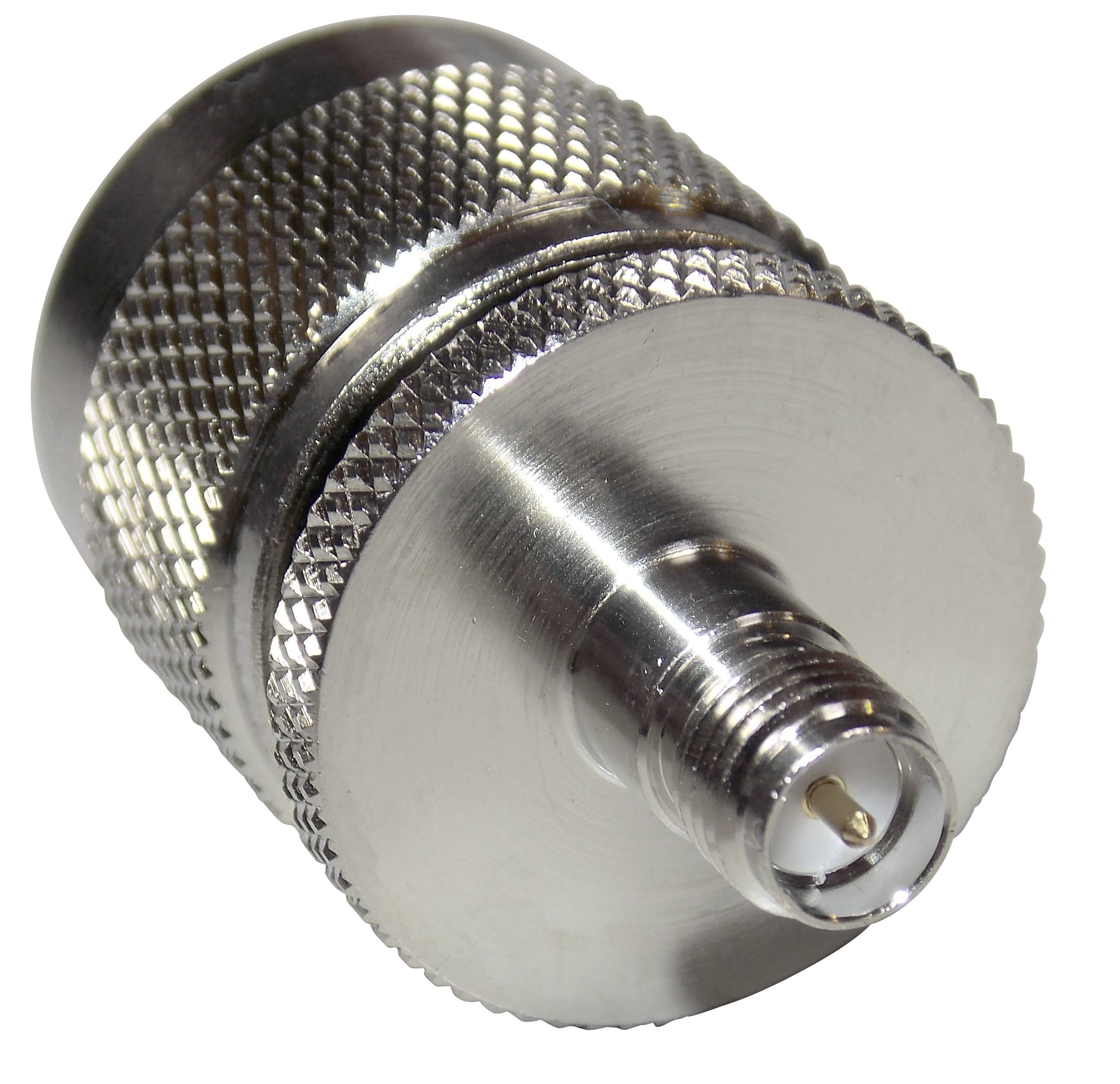 A silver coaxial plug with a ribbed surface texture, cylindrical in shape, and a central connection point for cable connections.