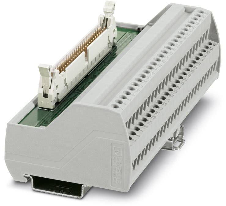 A grey electrical terminal block system with multiple wire connections, mounted on a green circuit board.
