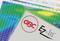 A GBC EZ-In™ laminating pouch packet lies on a colourful, blurred background, presumably a temperature chart.