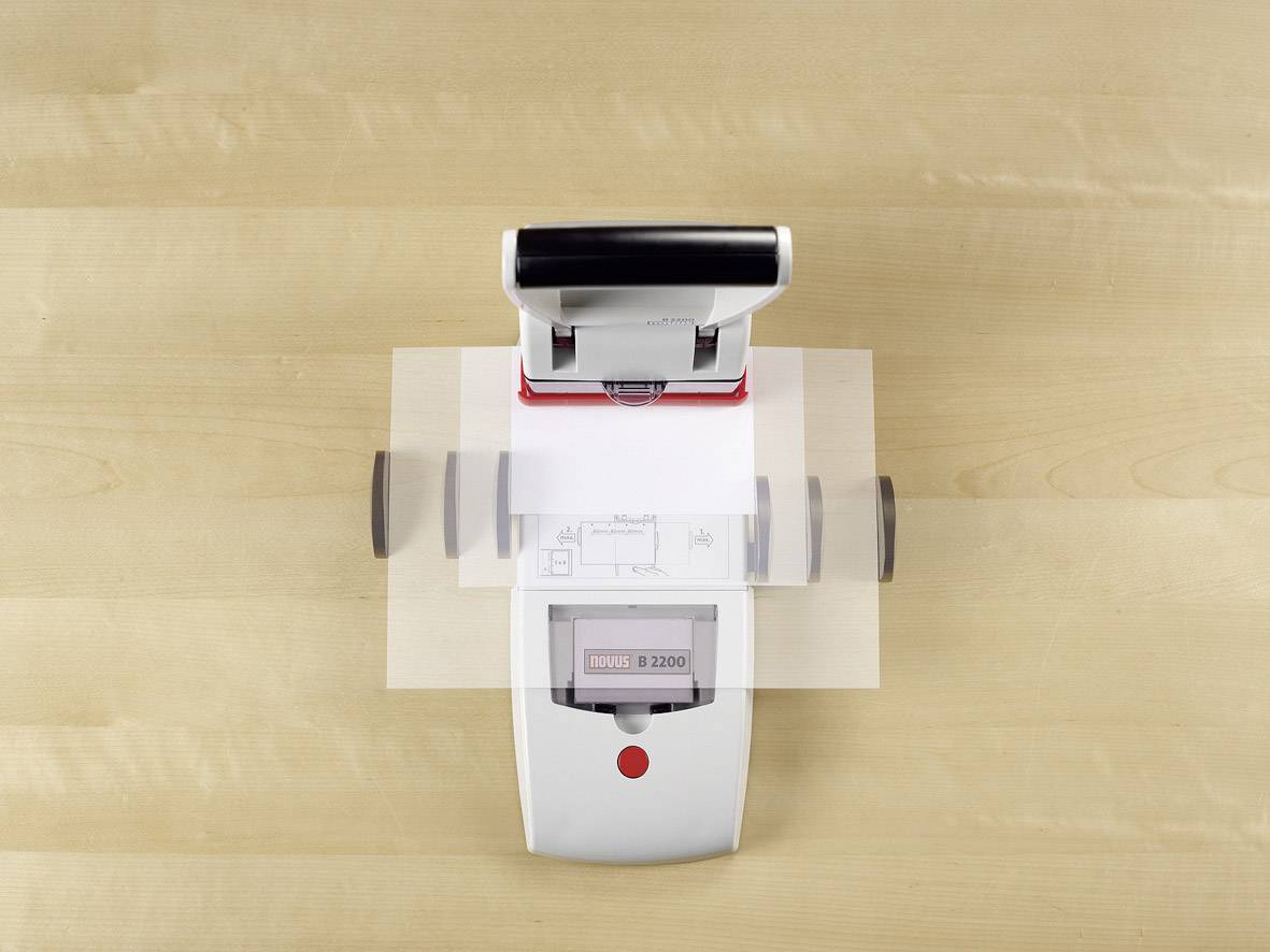 Electronic stamp on a wooden table, ready to stamp documents. A red button on the front activates the device.