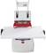 An electric hole punch is processing a thick stack of paper. It is white with red accents and has a robust construction.