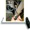 'The illustration shows a tool being used underneath a vehicle to remove or install an exhaust bracket.'