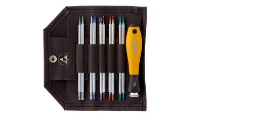 A tool set in a brown bag with six screwdriver bits in different colours and a yellow handle.
