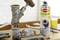 A rusty valve next to a spray can labelled 'Shock Rust Remover'. Tools are visible on a workbench in the background.