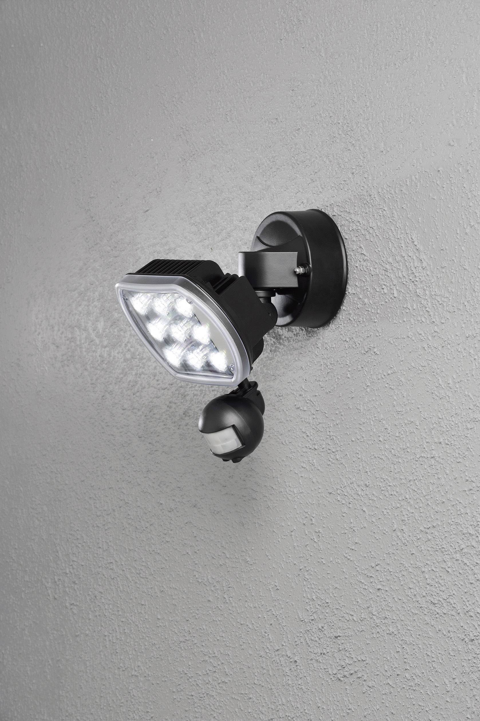 External wall light with a black housing, multiple LED lamps, and motion sensor, mounted on a grey wall.