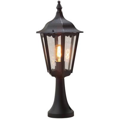 Black lantern in a classic style with transparent glass. A luminous light bulb is visible, emitting a warm light.