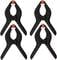Four black plastic spring clips with red handles on top, arranged symmetrically. They are used for holding objects.