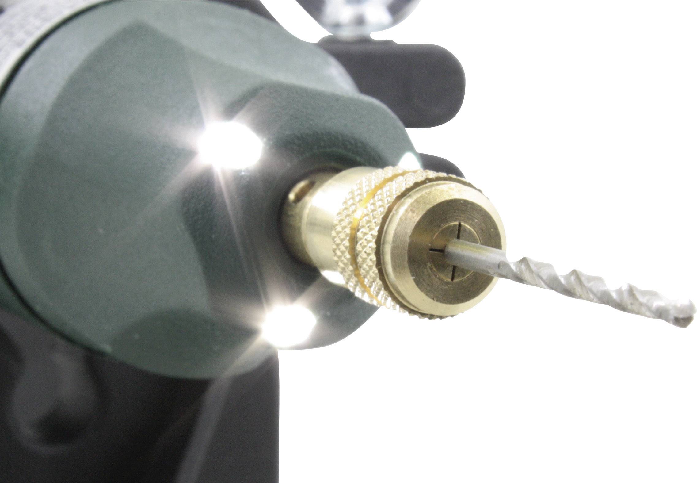 Close-up of a drill bit with a metal drill bit inserted, illuminated by two small, bright LED lights.