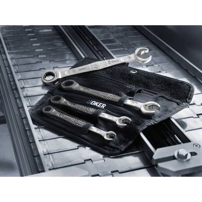 Four Spanner ring keys in different sizes lie on a tool bag on a metallic surface.