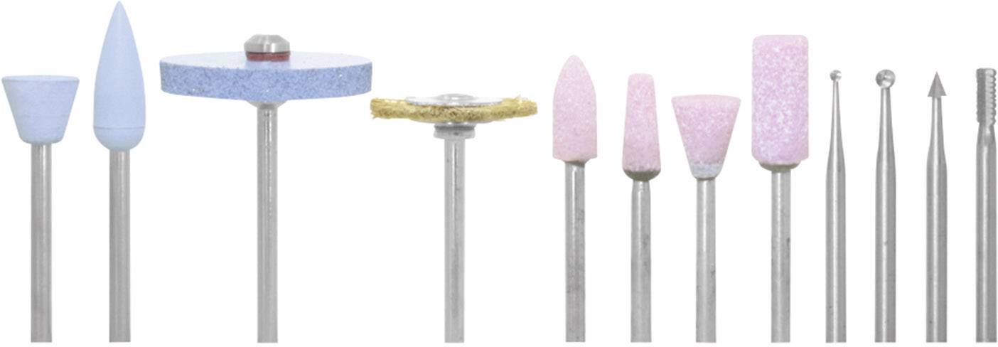 Various dental drills and grinding attachments, arranged in different shapes and colours, lined up on a surface.