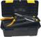 An open black toolbox with a yellow handle contains pliers, screwdriver and other tools.