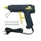 Black glue gun with yellow accents, two glue sticks and a power cable. Suitable for craft and repair work.