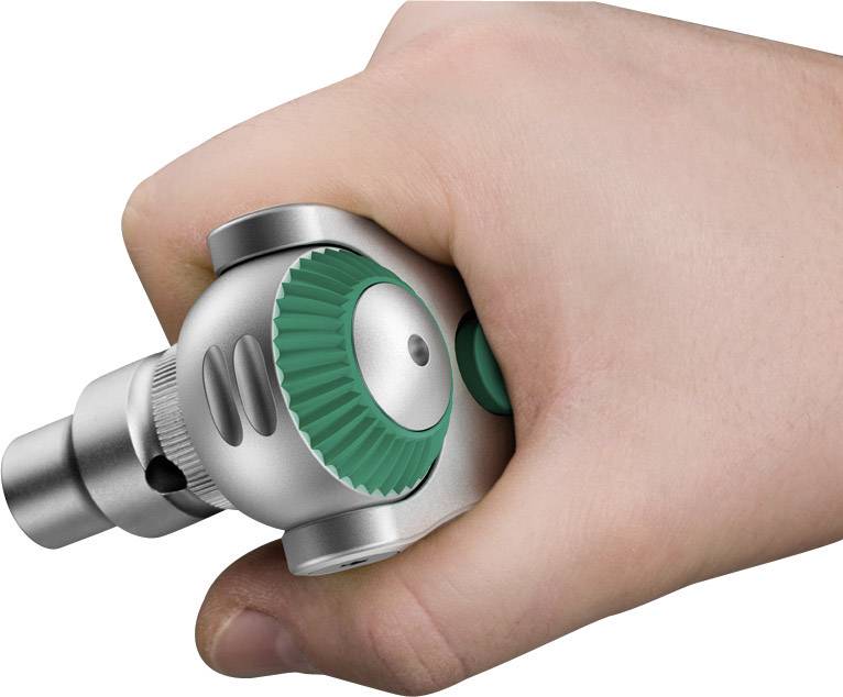 A hand is holding a rotating medical device, used for examination or treatment. The device has a green rotary knob.