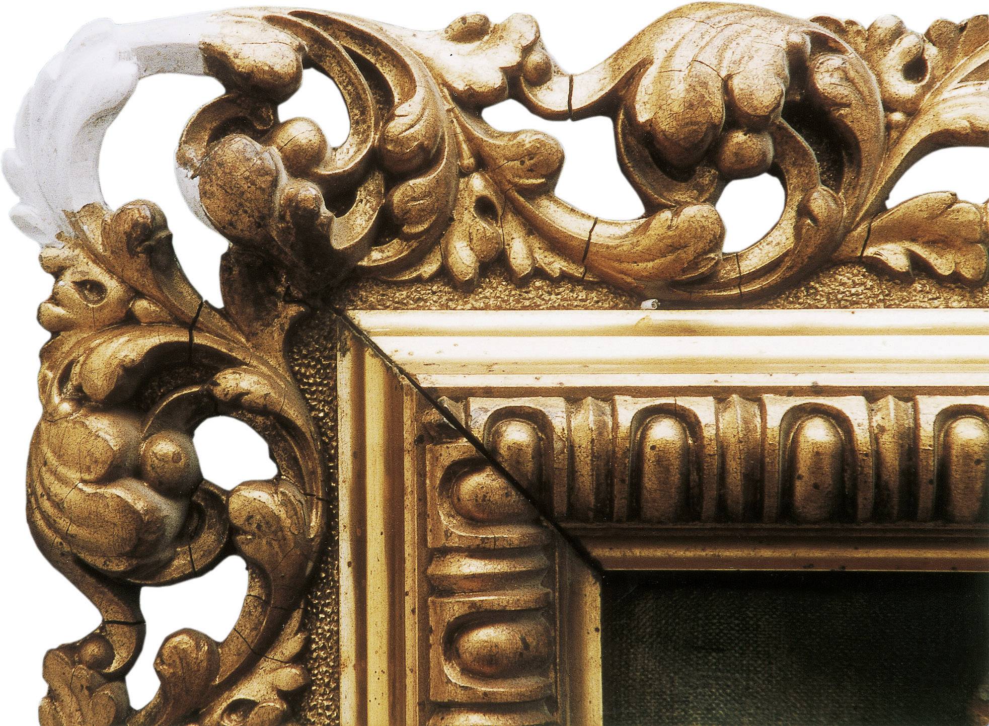 Wooden frame with intricate, golden carvings and floral patterns.