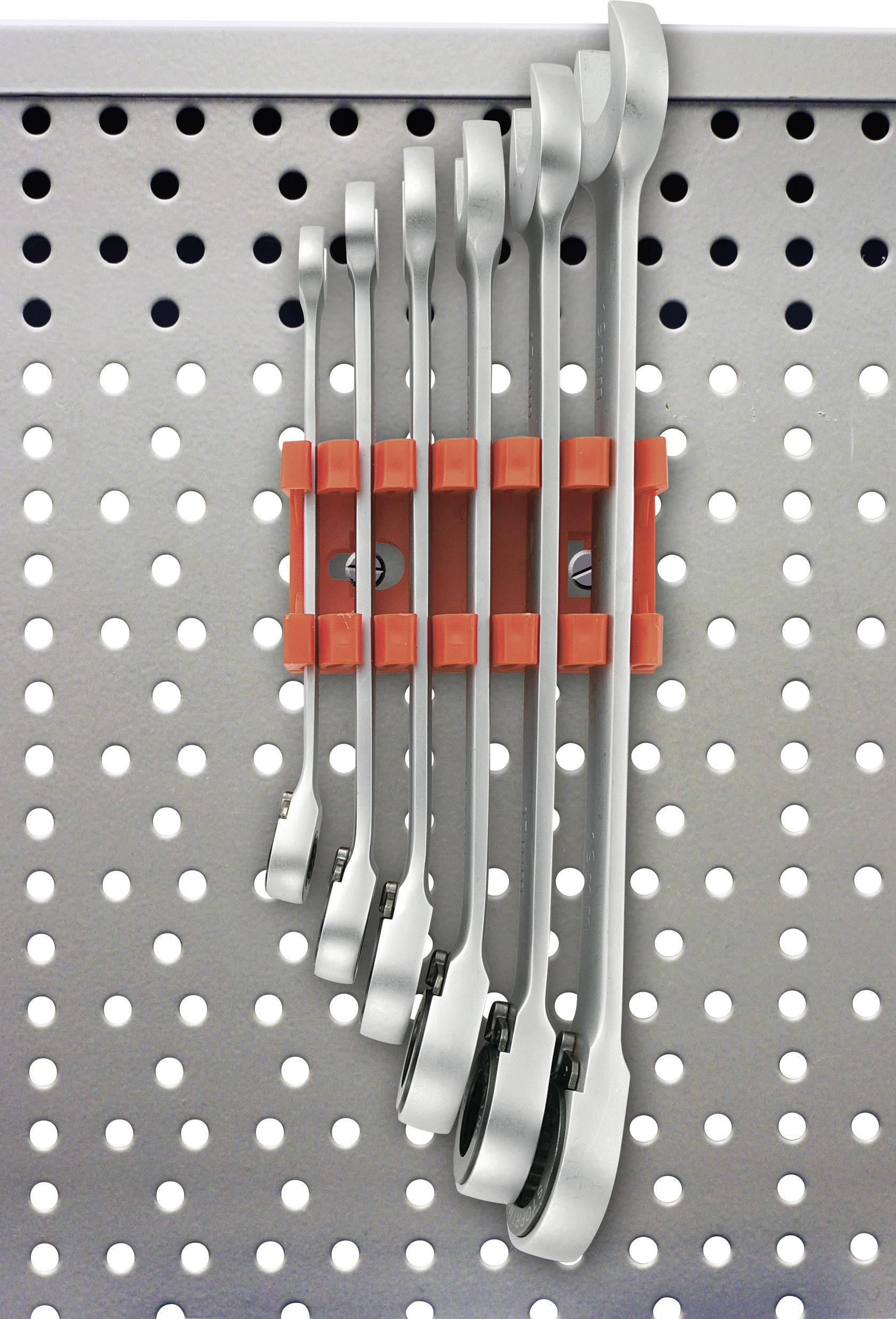 Six silver spanners hang in a red holder on a grey pegboard.