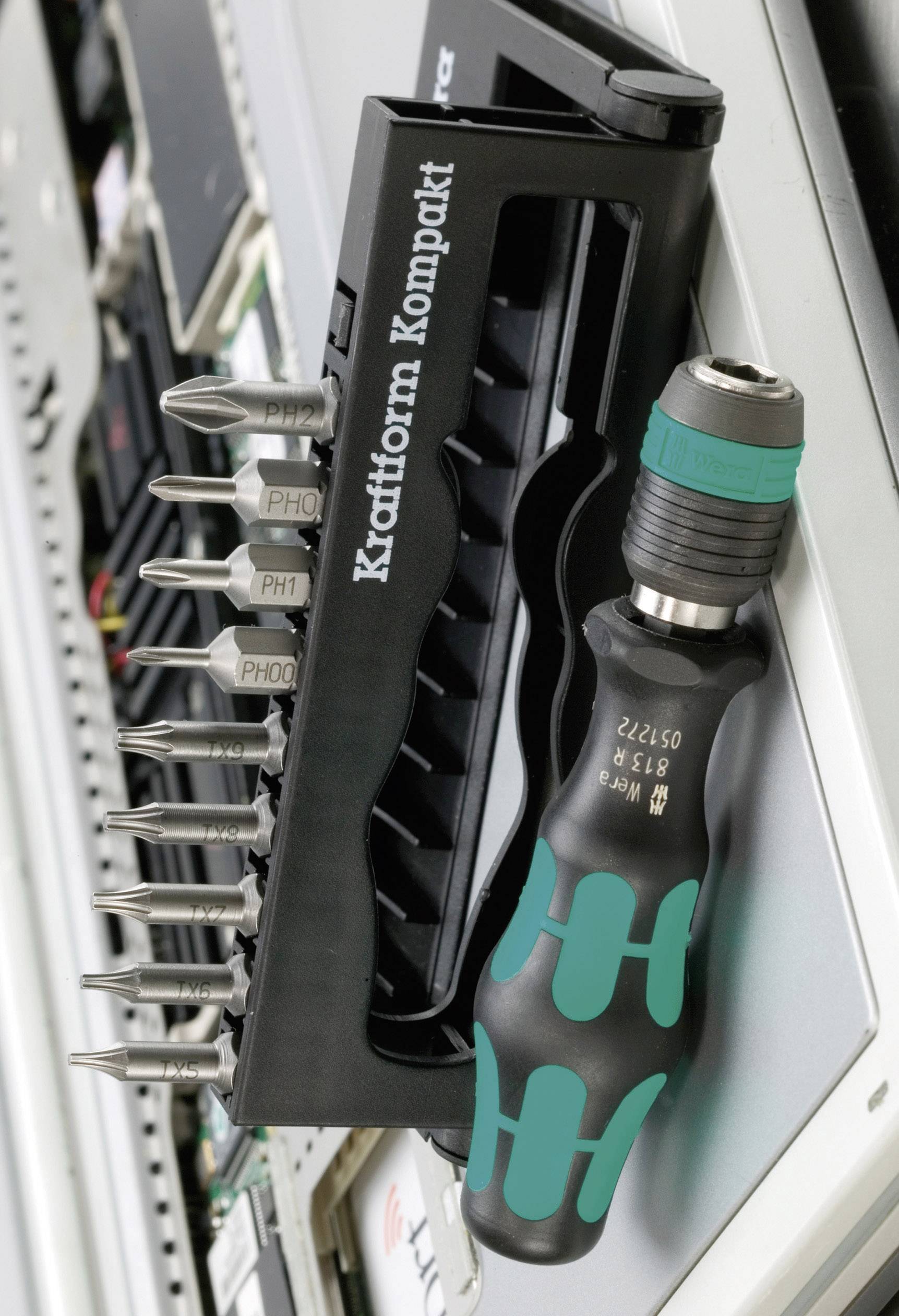 Cordless drill set with various bits and ergonomic handle, lying on a table. Ideal for versatile screw-driving tasks.