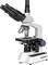 A white, professional microscope with black eyepieces and an objective stage. It is used for scientific investigations.