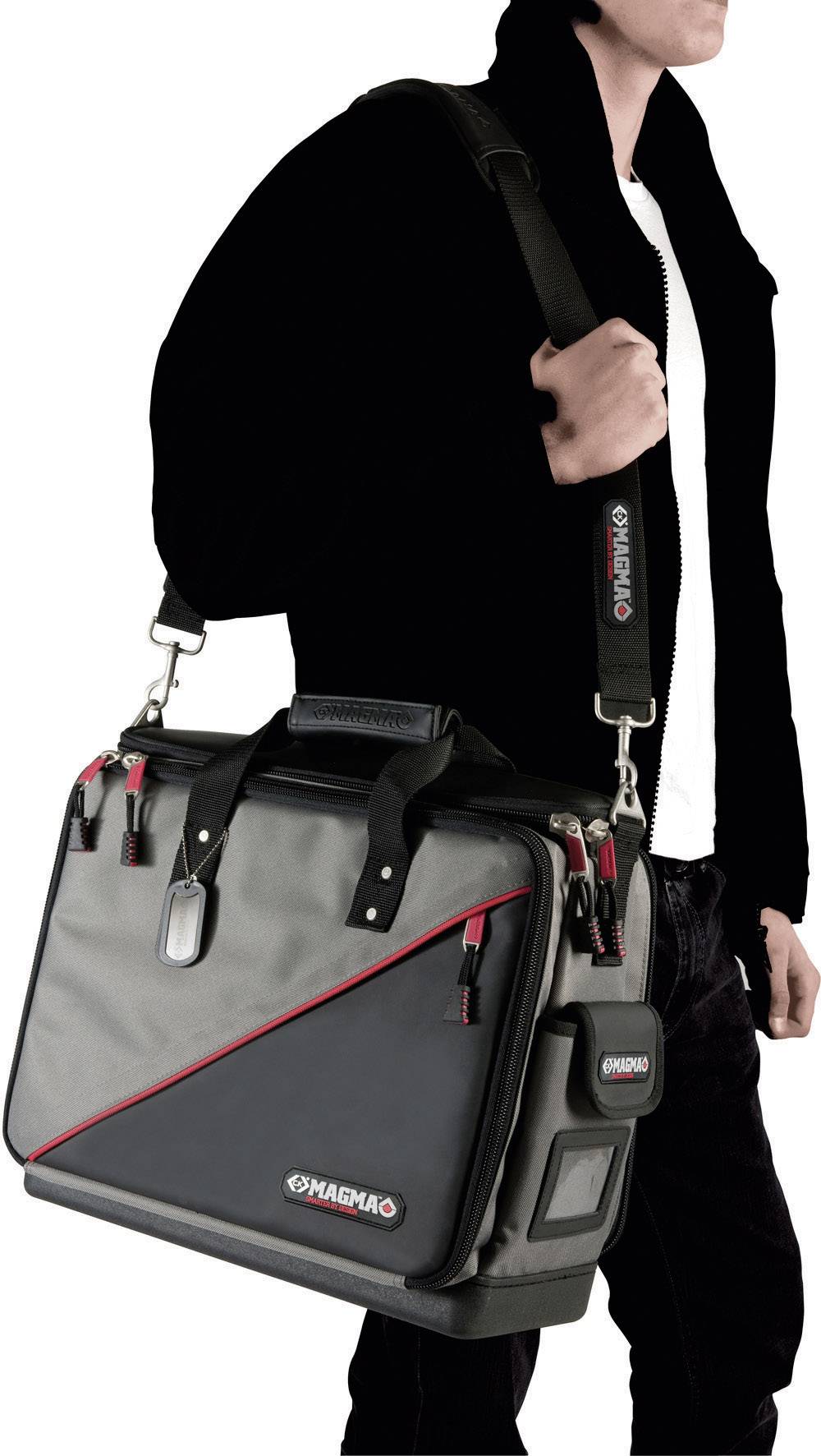 A person is carrying a black and grey messenger bag with red accents and the text 'MAGMA'.