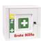 A first aid kit with a green cross and the inscription 'SÖHNGEN', containing medical symbols such as scissors and bandages.