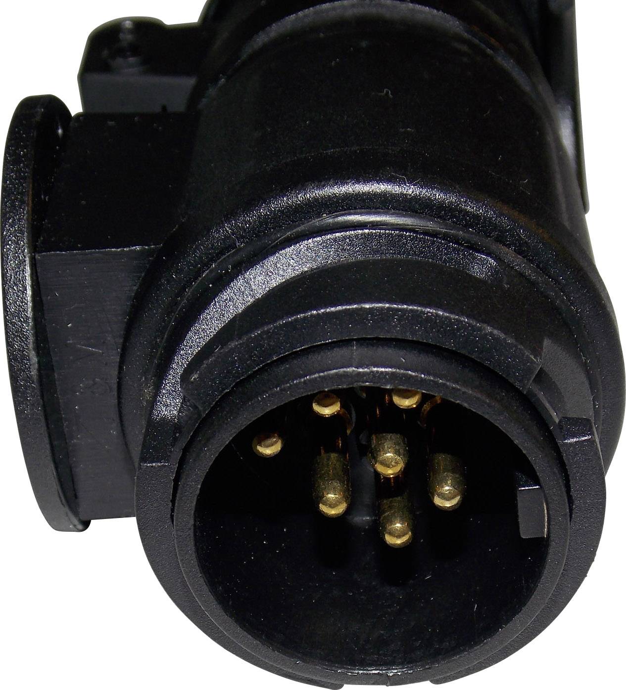 Close-up of a black, cylindrical plug with multiple golden pins inside. Used for electronic connections.