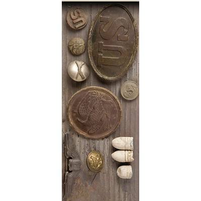 Various embossed metal and stone elements on a wooden surface. Main motifs: fish, letters, symbols.