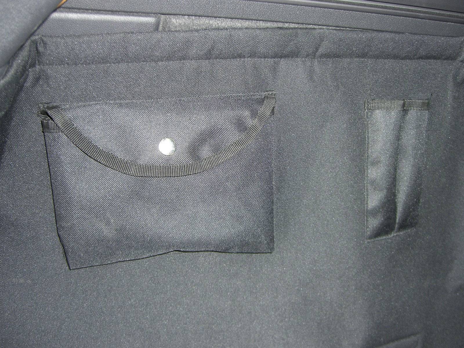 An open black bag with a flap pocket and a slim internal compartment.
