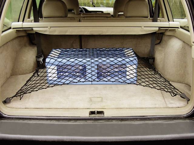 Boot of a car with a blue cardboard box secured by a net.
