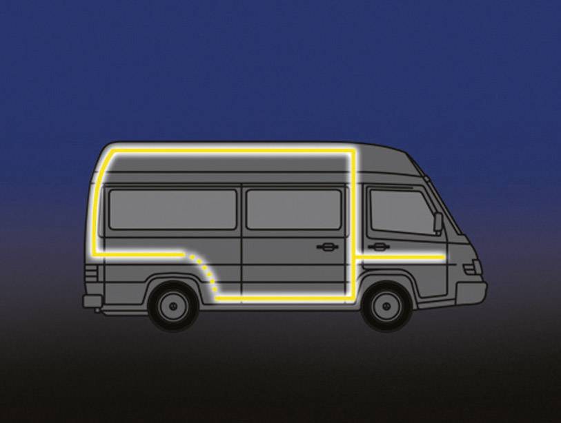 A van with a glowing outline in the twilight, highlighting the vehicle's contours.