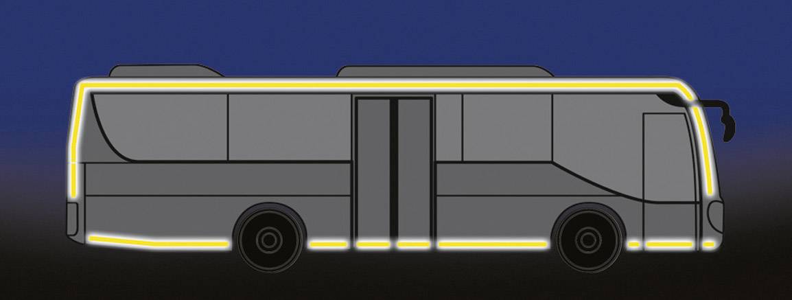 A grey bus with a yellow border on a dark background. The bus has two doors and no visible passengers.