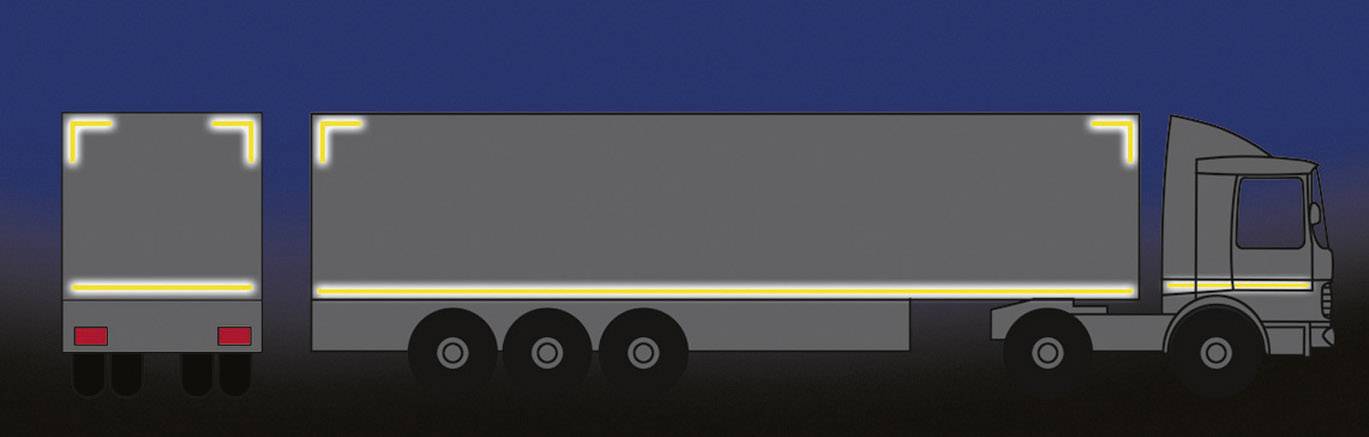 Lorry at night with reflective markings that clearly highlight the outlines of the trailer and rear for improved visibility.
